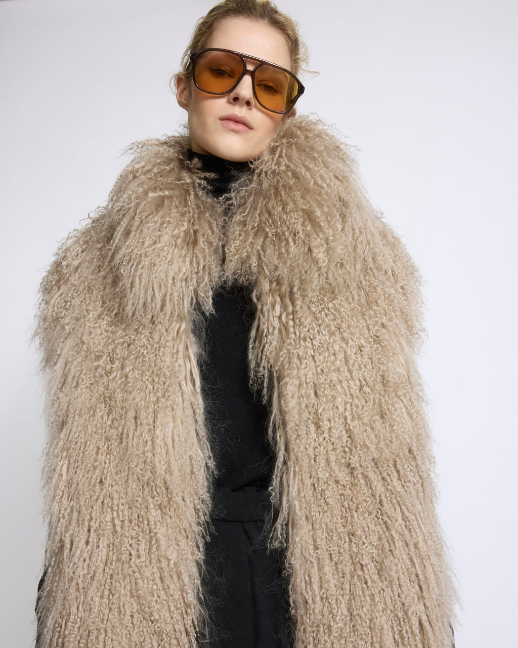 Merino knit gilet with curly long-haired lambskin