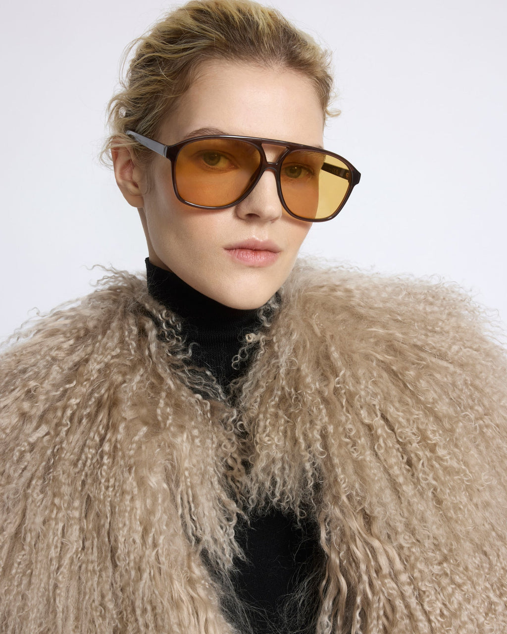 Merino knit gilet with curly long-haired lambskin